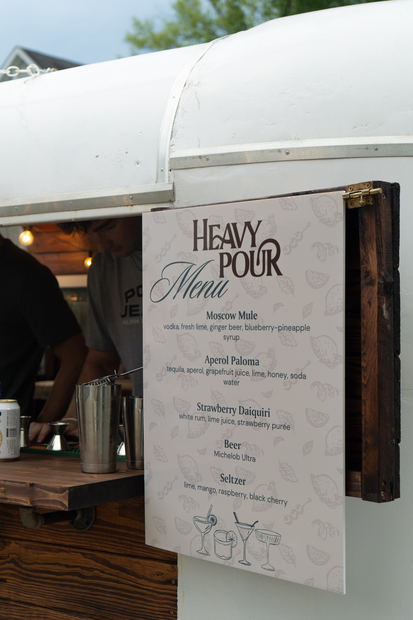 The Heavy Pour menu sign on the bar trailer door